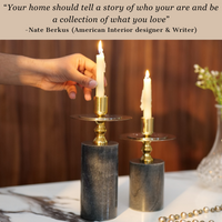 Elegant black and gold candlestick holders with lit candles on a wooden table. — thumbnail